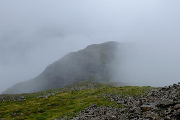 Photo of Aonach Dubh starting to appear from the mist
